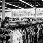 grayscale photography of people inside a clothing shop